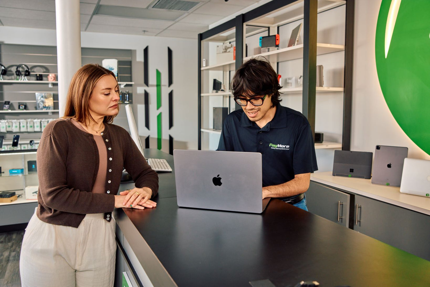 paymore employee inspecting a laptop